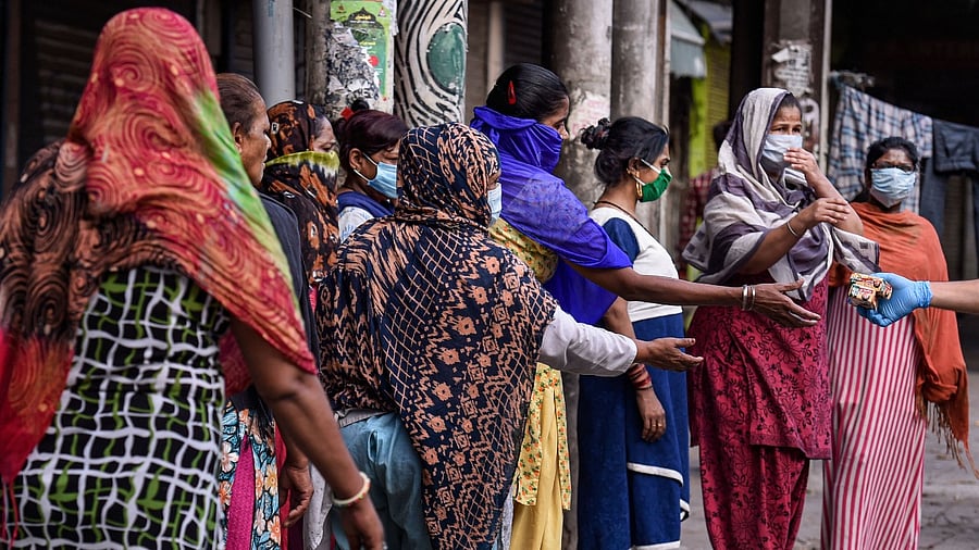 Sex workers wait to collect free groceries at the red-light area of Kamathipura in Mumbai, Friday, June 26, 2020. Credit: PTI File Photo