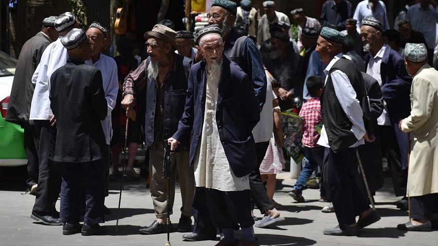 In this file photo taken on May 31, 2019 Uighur men are seen leaving a mosque after prayers in Hotan in China's northwest Xinjiang region. Credit: AFP.