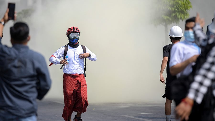 Protesters flee from teargas during a rally against the military coup in Yangon, Myanmar, February 27, 2021. Credit: Reuters File Photo