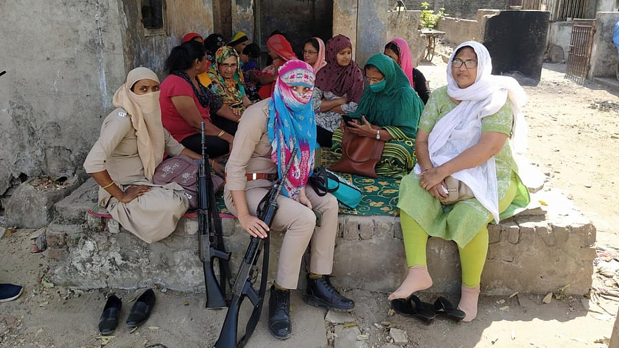 Women, all survivors of 2002 riots, at a group prayer. For the past several years, efforts are being made to negotiate with builders to sell the society. Credit: DH Photo/Satish Jha
