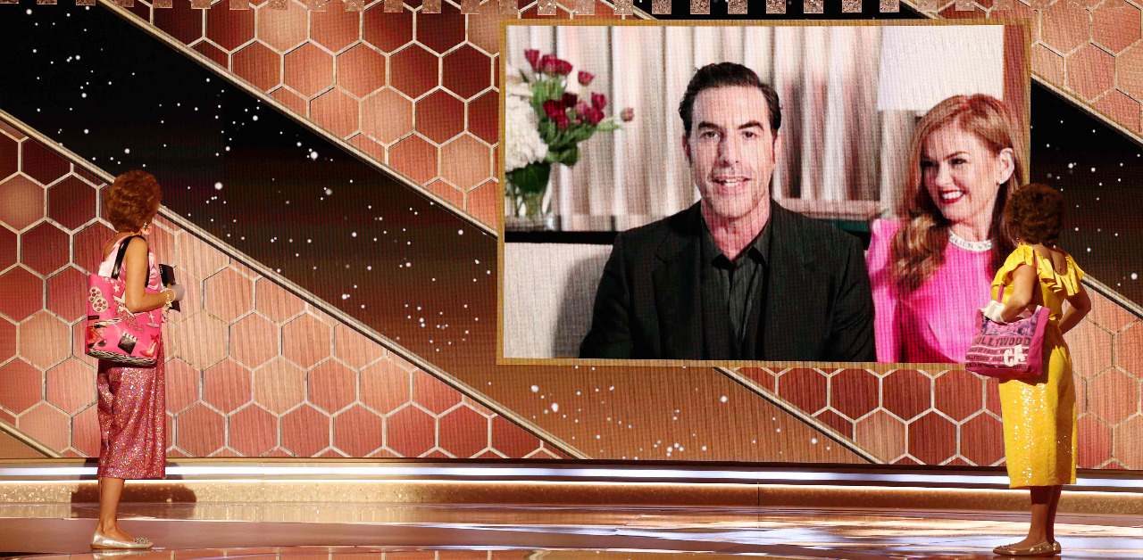 Sacha Baron Cohen with Isla Fisher as he accepts the Best Picture – Musical/Comedy award for 'Borat Subsequent Moviefilm'. Credit: AFP Photo/NBCUniversal / Christopher Polk