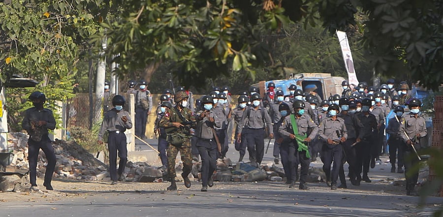 Myanmar riot police crossing blockage during a protest against the military coup in Mandalay, Myanmar. Credit: AP Photo