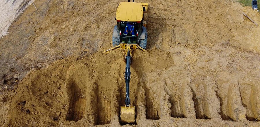 A tractor digging graves in a new area of the Nossa Senhora Aparecida cemetery reserved for COVID-19 victims, in Manaus, Brazil. Credit: AFP Photo