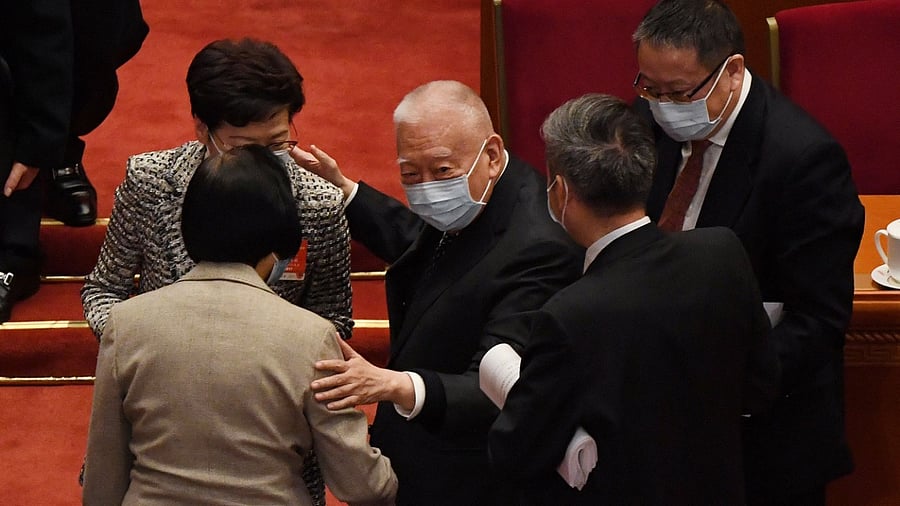 Former Hong Kong chief executive Tung Chee-hwa chats with Hong Kong Chief Executive Carrie Lam at the end of the opening session of the National People's Congress at the Great Hall of the People Credit: AFP Photo