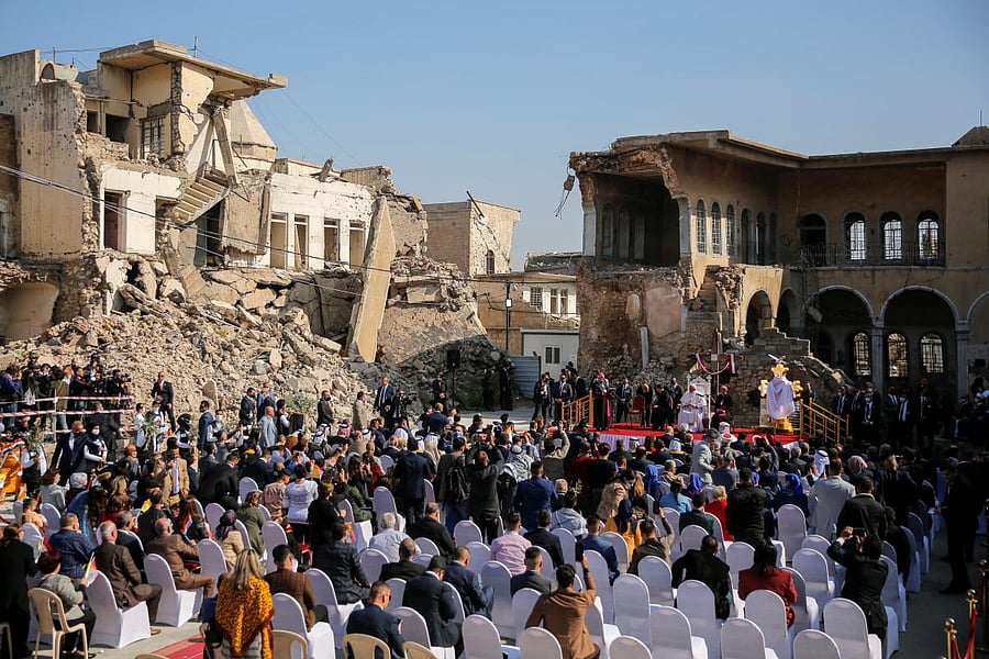 A general view picture shows people attending a prayer by Pope Francis for war victims at 'Hosh al-Bieaa', Church Square, in Mosul's Old City, Iraq, March 7, 2021. Credit: Reuters Photo