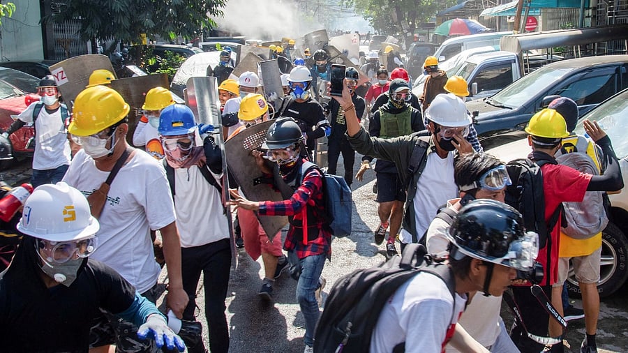 Protester run from police during a protest against the military coup in Yangon, Myanmar, March 8, 2021. Credit: Reuters Photo