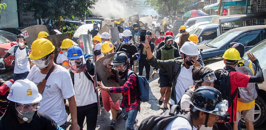 Protester run from police during a protest against the military coup in Yangon. Credit: Reuters Photo