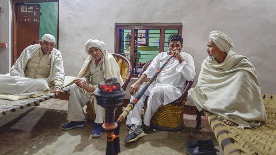 Legendary farm leader Mahendra Singh Tikait's son Narendra Tikait (2R) along with other family members, at his residence in Sisauli village, Muzaffarnagar. Credit: PTI.