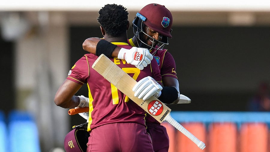 Shai Hope (R) of West Indies congratulate Evin Lewis (L) for his century during the 2nd ODI match between West Indies and Sri Lanka at Vivian Richards Cricket Stadium in North Sound, Antigua and Barbuda, on March 12, 2021. Credit: AFP Photo