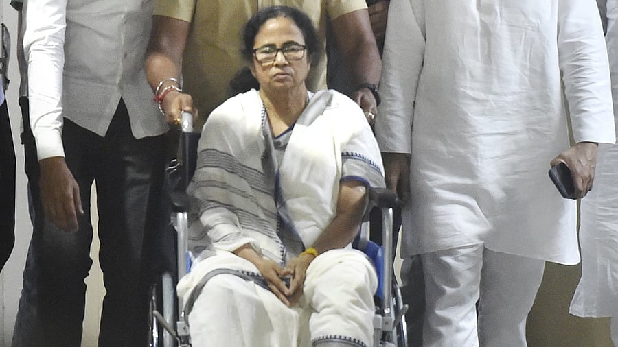 West Bengal Chief Minister Mamata Banerjee, sitting in a wheel-chair, being discharged from SSKM Hospital in Kolkata, Friday, March 12, 2021. Credit: PTI Photo
