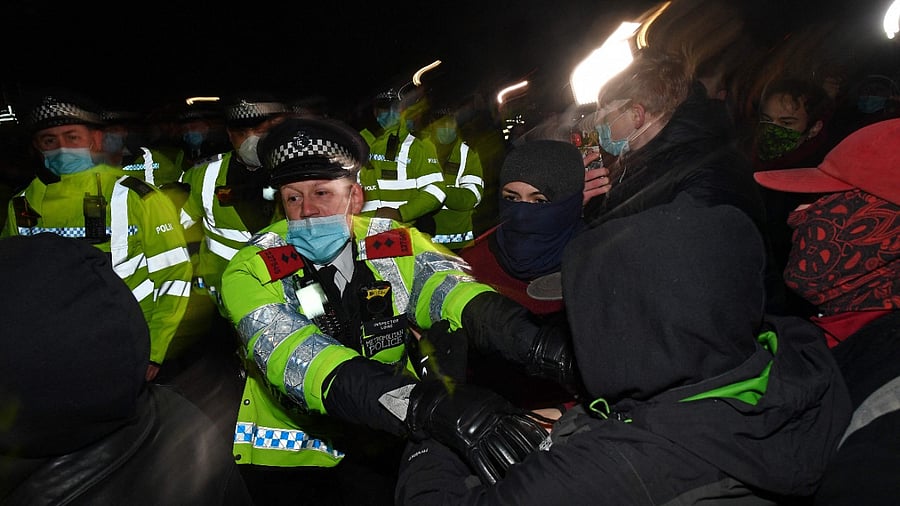 Police scuffle with people gathering at the band-stand where a planned vigil in honour of murder victim Sarah Everard, which was officially cancelled due to Covid-19 restrictions, was to take place on Clapham Common, south London. Credit: AFP Photo