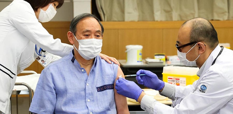 Suga is the first Japanese government official to publicly receive the vaccine. Credit: AFP photo.