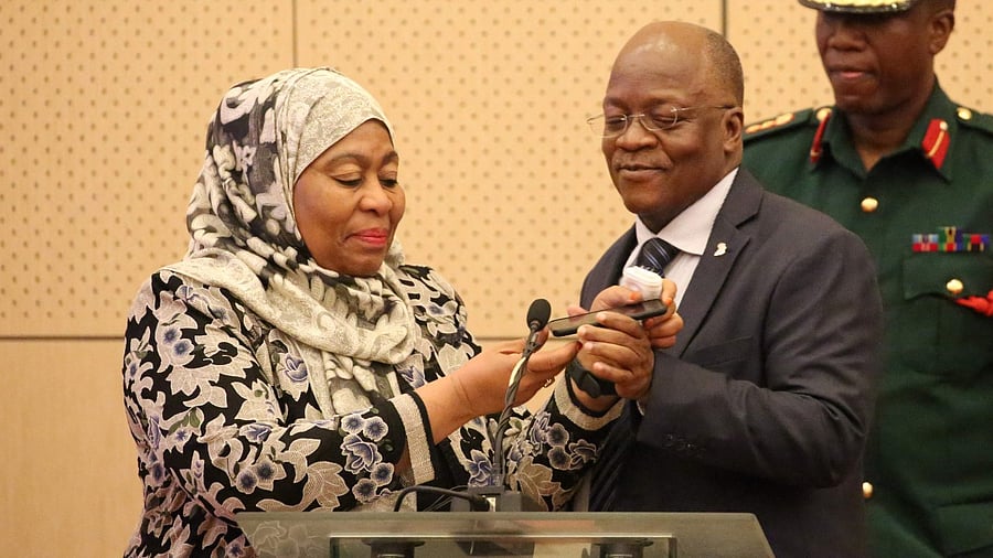 Tanzania's new President Samia Hassan Suluhu (L) and the late John Magufuli (C). Credit: AFP File Photo