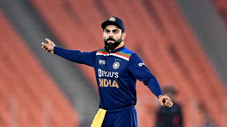 India's captain Virat Kohli watches as he fields during the fourth Twenty20 international cricket match between India and England at the Narendra Modi Stadium in Motera on March 18, 2021. Credit: AFP Photo