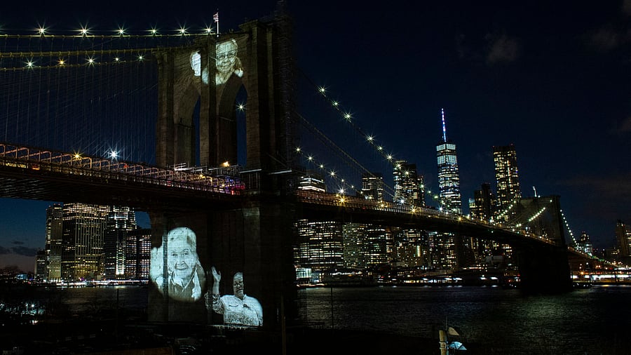 Images of Covid-19 Victims are projected over the Brooklyn bridge as the city commemorates a Covid-19 Day of Remembrance. Credit: AFP Photo