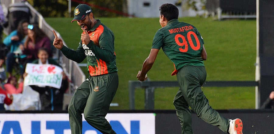 Mustafizur Rahman (R) and Tamim Iqbal celebrate the dismissal of Martin Guptill. Credit: AFP Photo