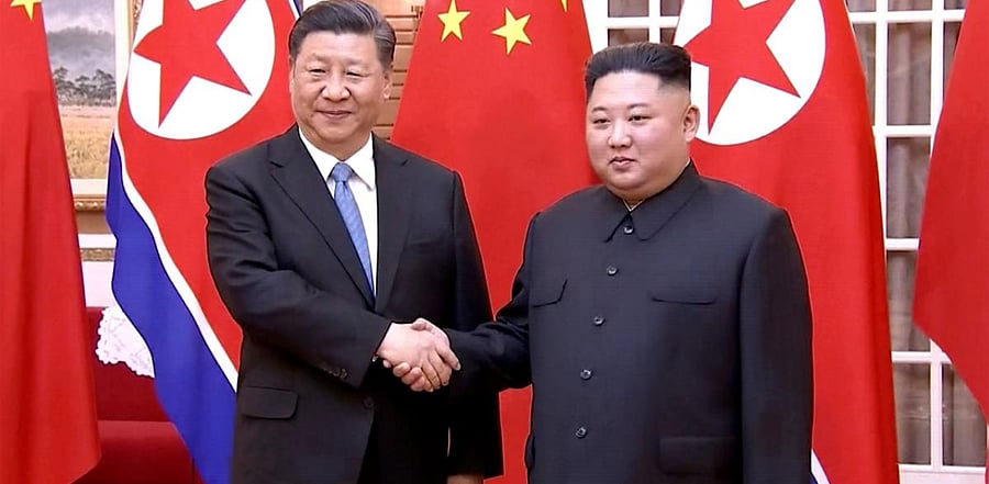 Chinese President Xi Jinping (L) with North Korean leader Kim Jong-un. Credit: AFP photo.