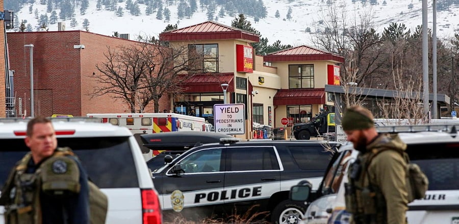 Law enforcement officers stand at the perimeter of a shooting site at a King Soopers grocery store in Boulder. Credit: Reuters Photo