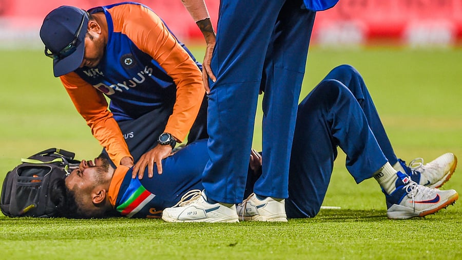 India's Shreyas Iyer reacts laying on the ground after being injured while fielding during the first one-day international (ODI) cricket match between India and England at the Maharashtra Cricket Association Stadium in Pune. Credit: AFP Photo