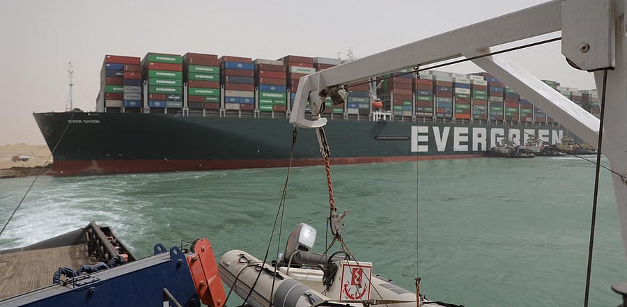 Egyptian tug boats trying to free Taiwan-owned cargo MV Ever Given (Evergreen), a 400-metre- (1,300-foot-)long and 59-metre wide vessel. Credit: AFP Photo
