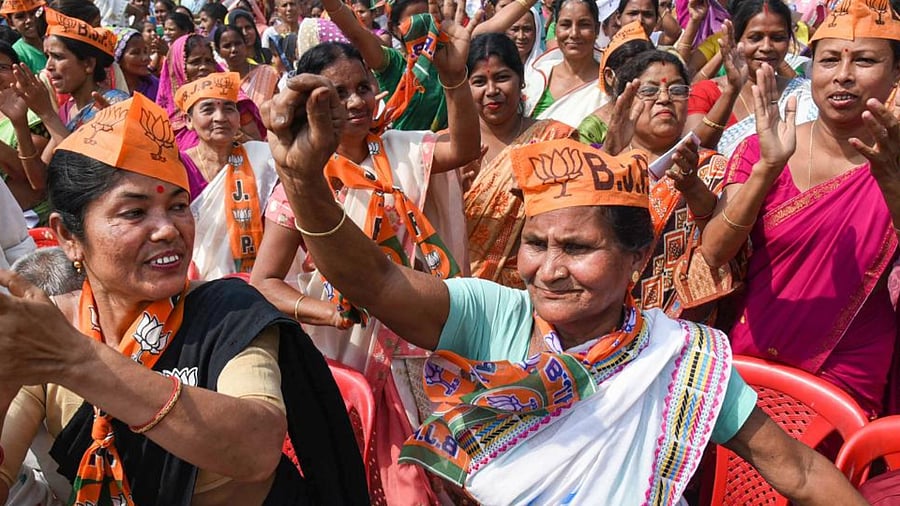 BJP supporters perform a dance during an election campain rally at Chamata in Nalbari district of Assam, Friday, March 26, 2021. Credit PTI Photo