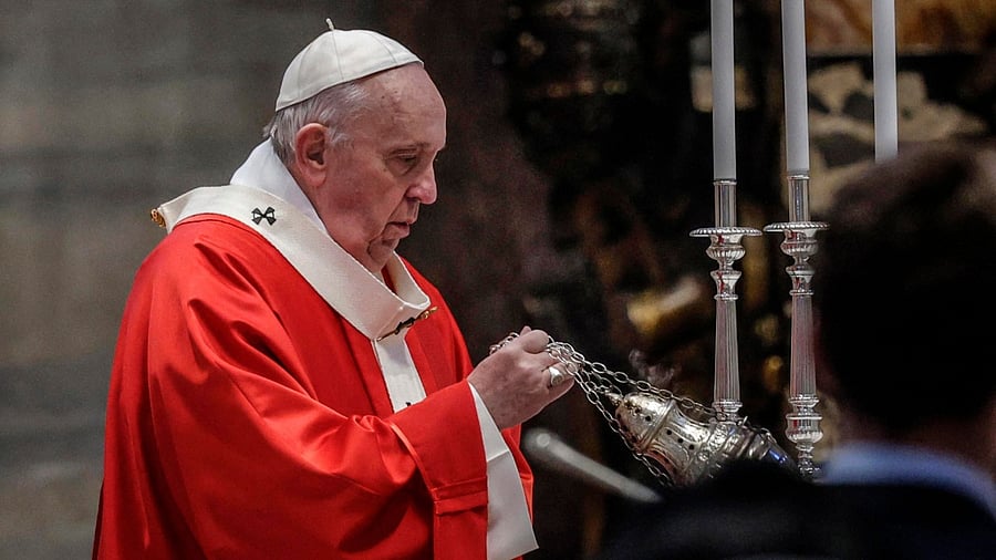 Pope Francis swings a thurible of incense around the altar as he celebrates Palm Sunday mass. Credit: AFP Photo