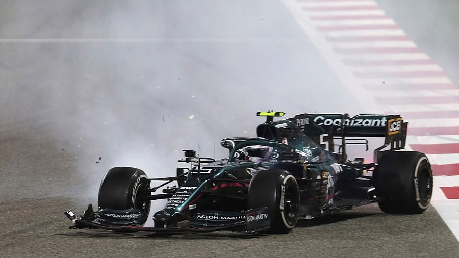 Aston Martin driver Sebastian Vettel of Germany crashes with Alpine driver Esteban Ocon of France during the Bahrain Formula One Grand Prix at the Bahrain International Circuit in Sakhir, Bahrain, Sunday, March 28, 2021. Credit: AP/PTI Photo