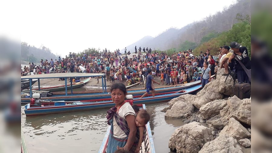 Karen refugees carrying belongings are seen at Salween riverbank in Mae Hong Son, Thailand March 29, 2021. Credit: Reuters