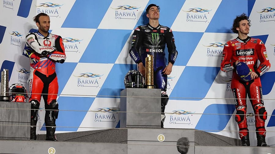 Monster Energy Yamaha MotoGP's Spanish rider Maverick Vinales (C), Pramac Racing's French rider Johann Zarco (L) and Ducati Lenovo Team's Italian rider Francesco Bagnaia celebrate the Moto GP Qatar Grand Prix at the Losail International Circuit, in the city of Lusail. Credit: AFP.