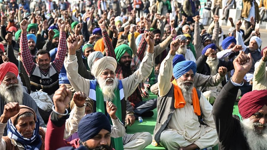 Protesting farmers shout slogans as they sit along a blocked highway during a protest against the central government's recent agricultural reforms at the Ghazipur Delhi-Uttar Pradesh state border in New Delhi on January 11, 2021. Credit: AFP Photo