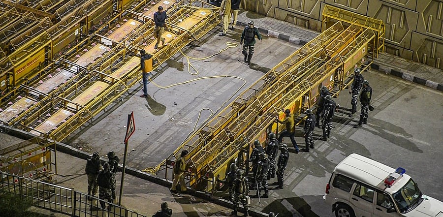 Police personnel set up barricades at Ghazipur border, ahead of farmers' proposed 'Chakka Jam' against the Centre's three agri laws. Credit: PTI Photo