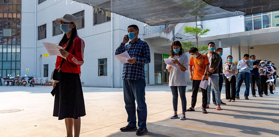 People lining up and getting vaccinated in Ruili. Credit: AP Photo