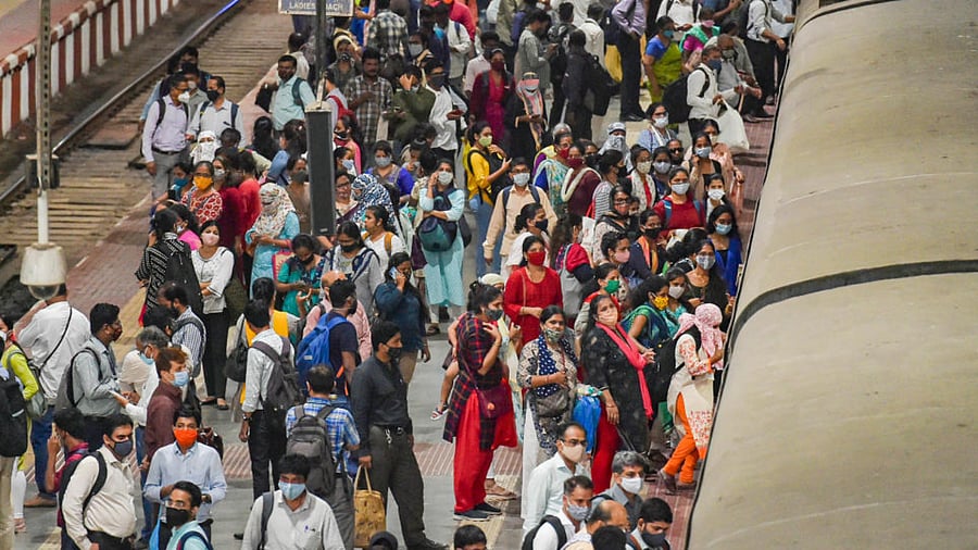 Commuters rush to board a suburban train at CSMT station prior to the night curfew, amid coronavirus pandemic, in Mumbai, Tuesday, March 30, 2021. Credit: PTI Photo