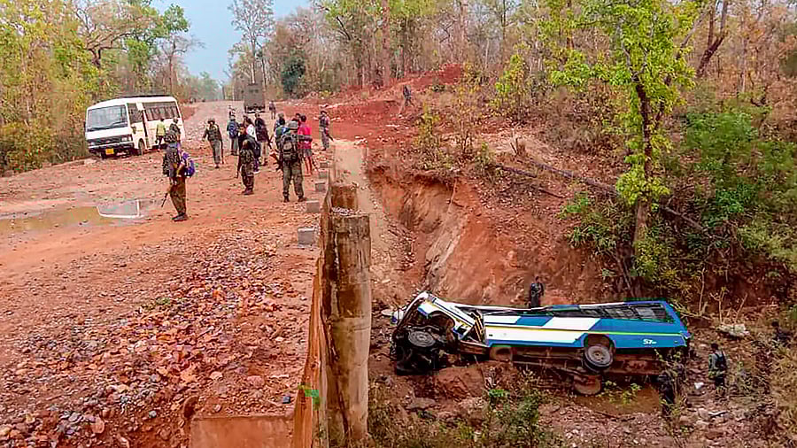 In this photo provided by the Indo Tibetan Border Police, security officers patrol the site of a bombing allegedly by Maoist rebels, killing atleast four policemen, in Narayanpur district of Chhattisgarh. Credit: PTI Photo