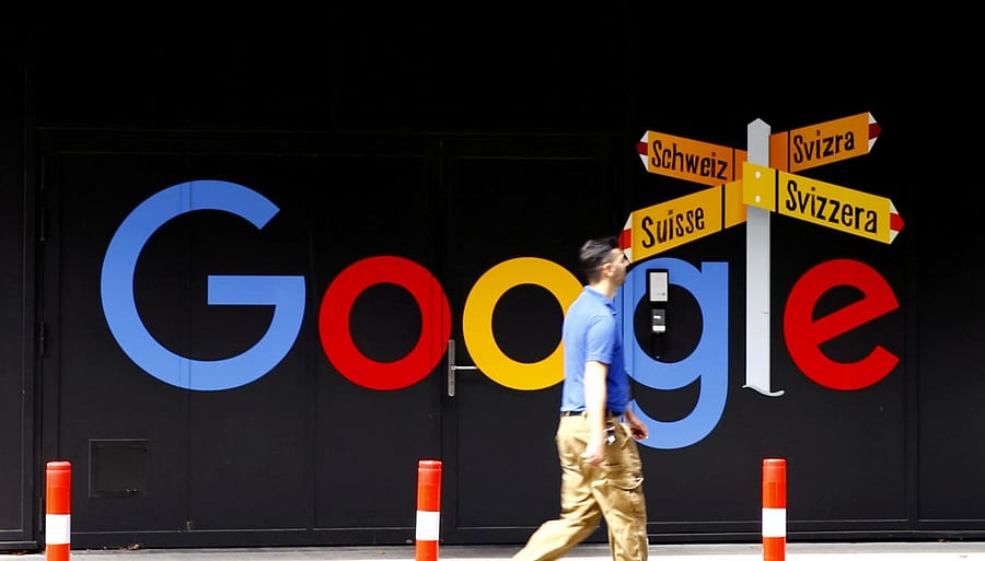 REUTERS FILE PHOTO: A man walks past a logo of Google in Zurich.
