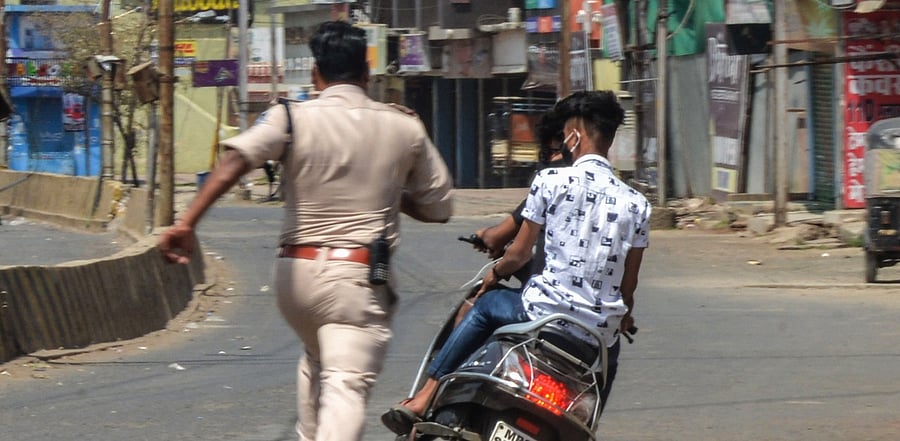 A policeman chasing Covid-19 lockdown violators. Credit: PTI photo