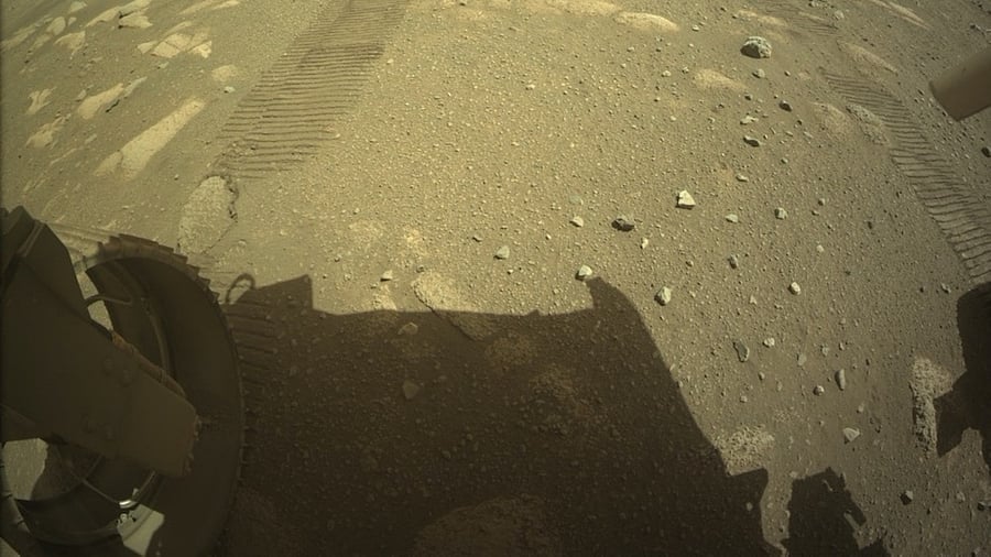 This NASA photo shows NASA’s Ingenuity Mars Helicopter on the ground behind the Perseverance rover. Credit: AFP Photo