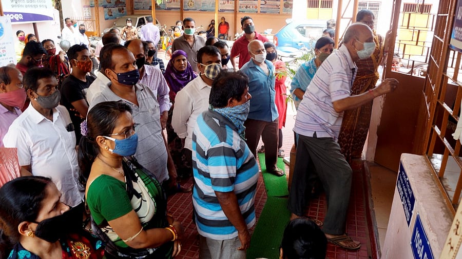 Beneficiaries wait in queues to receive the Covid-19 vaccine doses at a PHC, in Bhubaneswar. Credit: PTI.