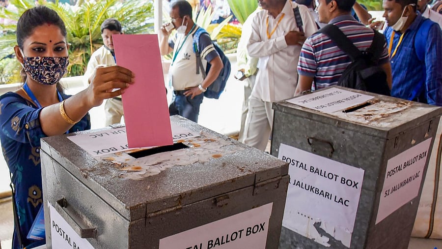  Polling officials cast their votes for the 3rd phase of State Assembly polls through postal voting. Credit: PTI Photo