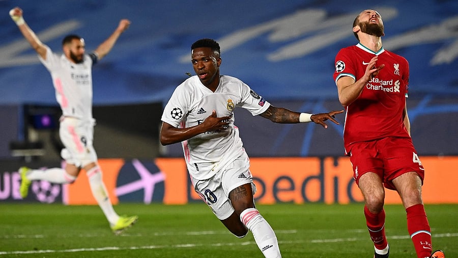 Real Madrid's Brazilian forward Vinicius Junior (C) celebrates after scoring a goal during the UEFA Champions League first leg quarter-final football match between Real Madrid and Liverpool. Credit: AFP Photo