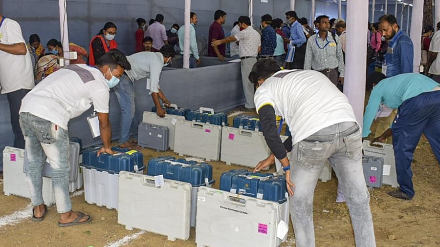 Workers arrange EVMs and other election material at a distribution centre, on the eve of the first phase of Assembly polls, in Bankura, Friday, March 26, 2021. (PTI Photo)