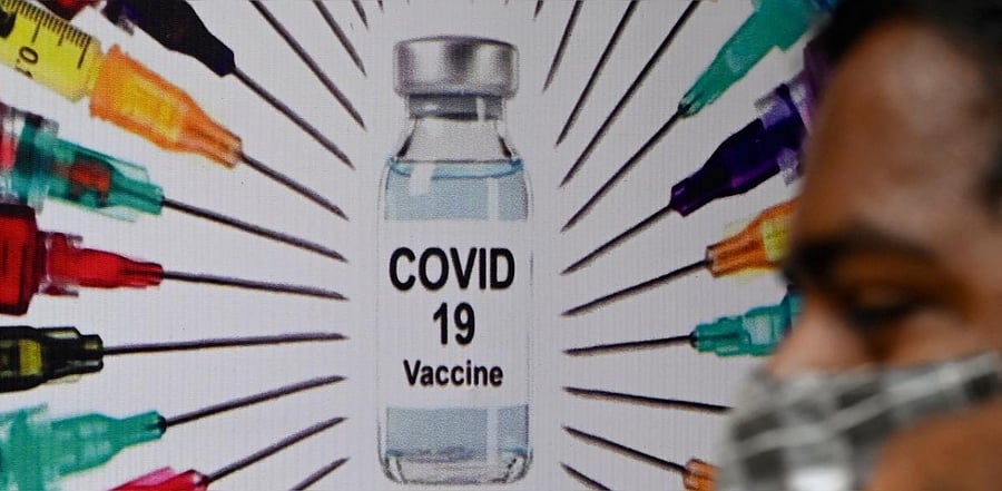 A man waits at a Covid-19 vaccination centre, in Mumbai. Credit: AFP photo.