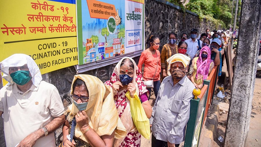 Beneficiaries gather outside a vaccination centre due to shortage of Covid-19 vaccine, amid coronavirus pandemic, at Goregaon in Mumbai. Credit: PTI photo.
