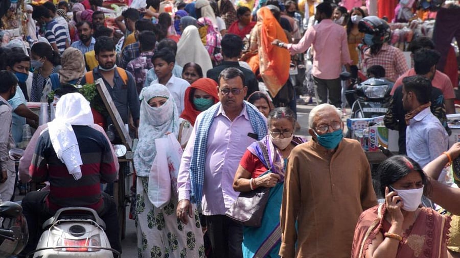 People gather at a market area, amid the ongoing surge in coronavirus cases, in Kanpur, Sunday, April 11, 2021. Credit: PTI Photo