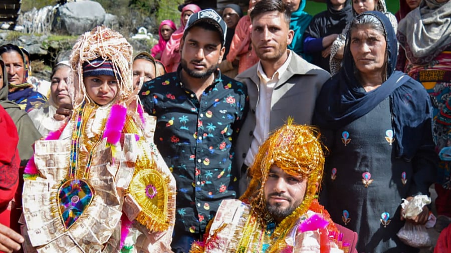 In this undated photo, a bridegroom poses for photos with his family members and relatives during his wedding ceremony at a village along the LOC. Credit: PTI Photo