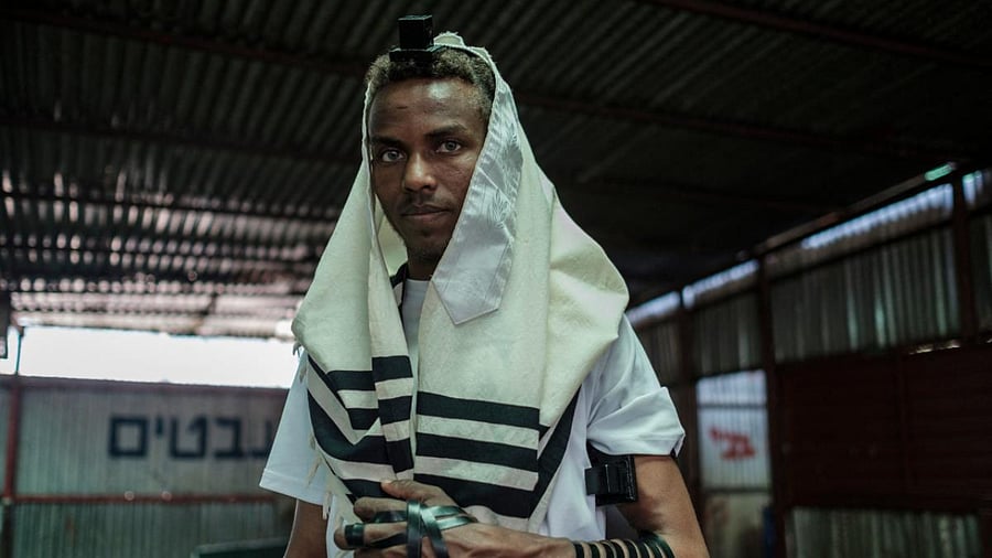Ayele Andebet, a 23-year-old who spent six months studying in Israel and hopes to return permanently one day, poses for a portrait at the building of the Ethiopian Jewish community in the city of Gondar, Ethiopia. Credit: AFP photo.