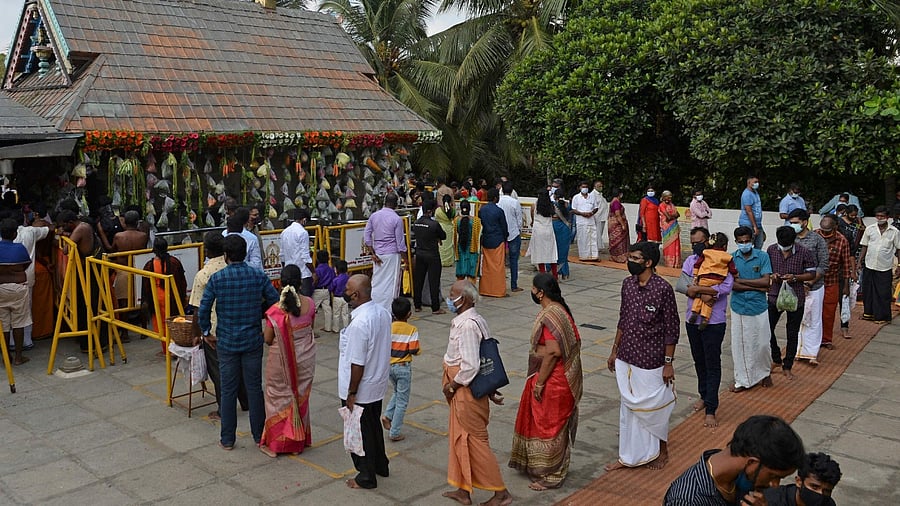 A large number of people thronged temples across the state to have the glimpse of 'vishukani' arranged there since wee hours. Credit: AFP Photo