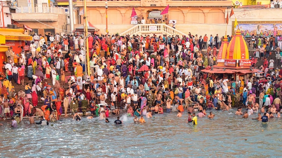 Devotees gather to offer prayers during the third 'Shahi Snan' of the Kumbh Mela 2021. Credit: PTI Photo