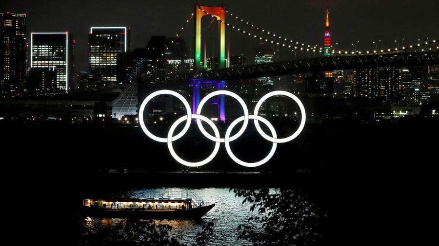 The Rainbow Bridge and Tokyo Tower are illuminated with Olympic colours to mark 100 days countdown to the Tokyo 2020 Olympics. Credit: Reuters photo. 