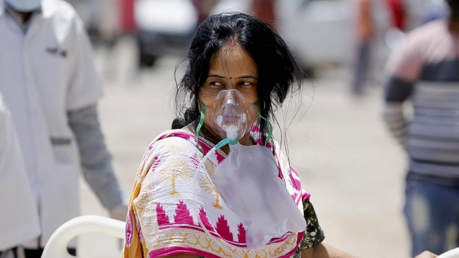 Health workers move a stable patient to another hospital to make space for critical COVID-19 patients, at Government Civil Hospital in Ahmedabad, Saturday, April 17, 2021.